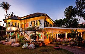 Issaya Siamese Club’s historic villa and gardens by night