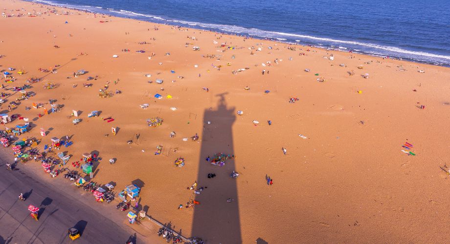 Aerial view of Marina Beach, Chennai, with lighthouse shadow
