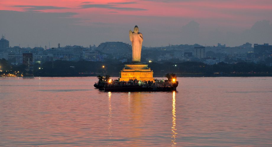 Statue of Buddha lit up at sunset in Hussain Sagar Lake, Hyderabad