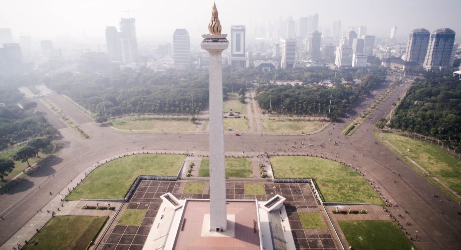 Jakarta’s Monas Tower in a landscaped park with skyscrapers beyond