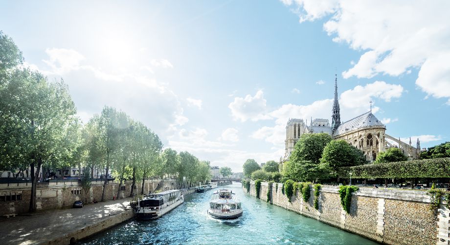 Boats on the Seine passing Notre Dame in Paris