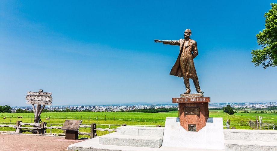 Statue of Dr. William S. Clarke on Hitsujigaoka Hill in Sapporo against blue sky