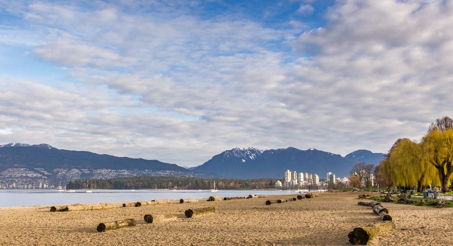 View of Vancouver’s Kitsilano Beach with mountains in background