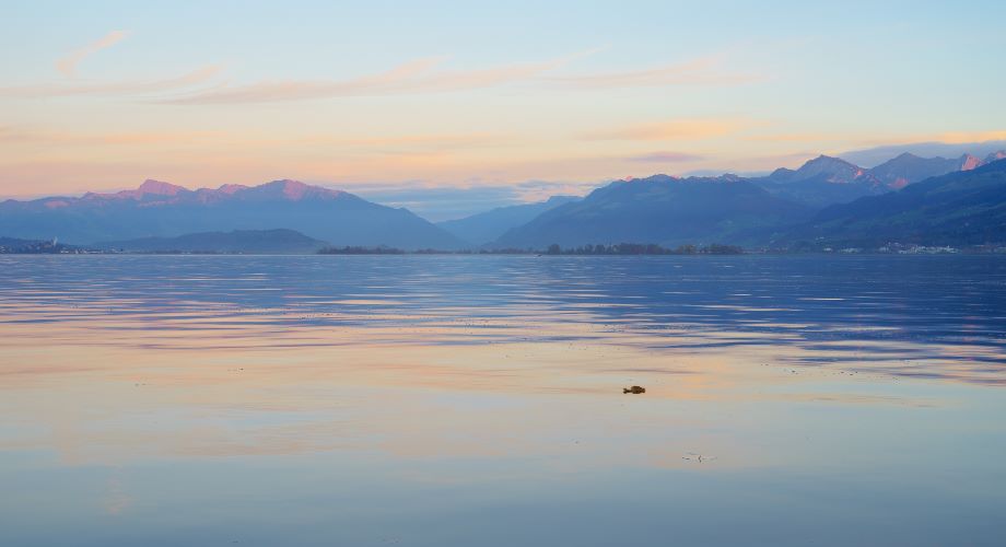 View over Lake Zurich to misty Swiss mountains