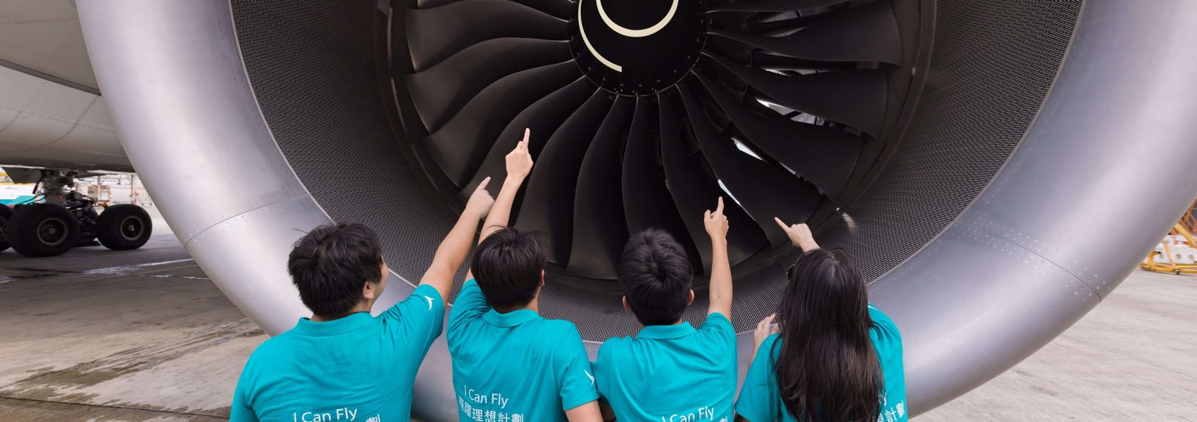 A group of people standing in a line with their hands up