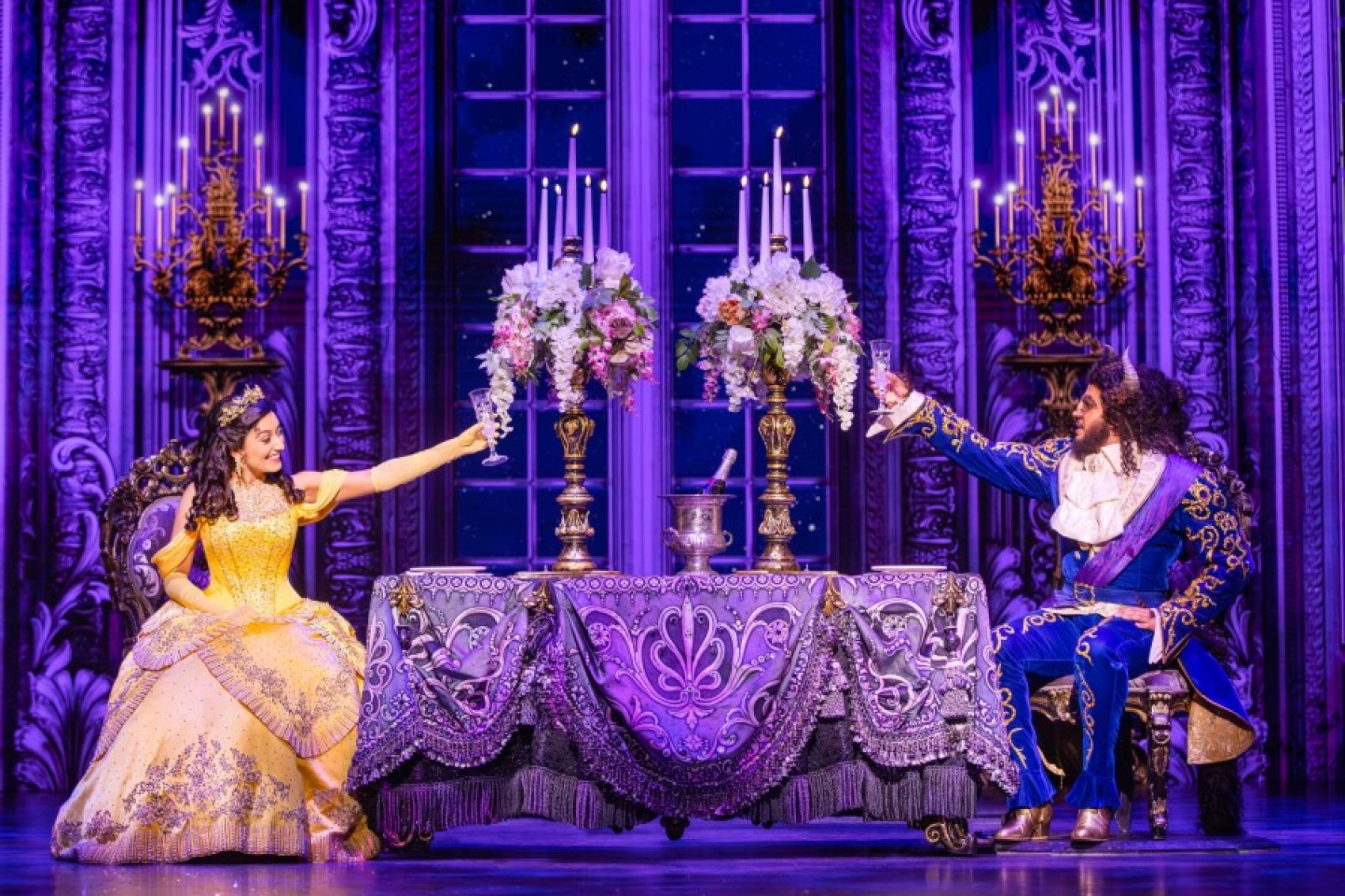 A scene from "Beauty and the Beast" performed at the Broadway Theatre, showcasing vibrant costumes and stage design.