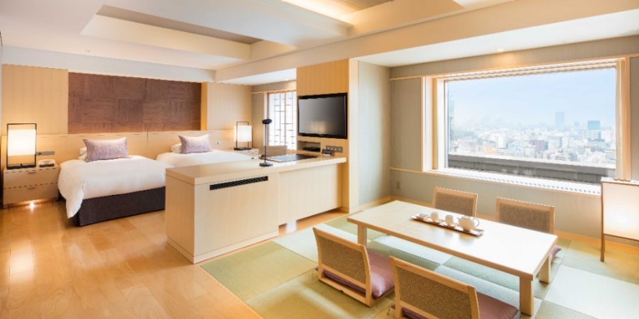 A bright living room with large windows showcasing a stunning view of the city skyline.