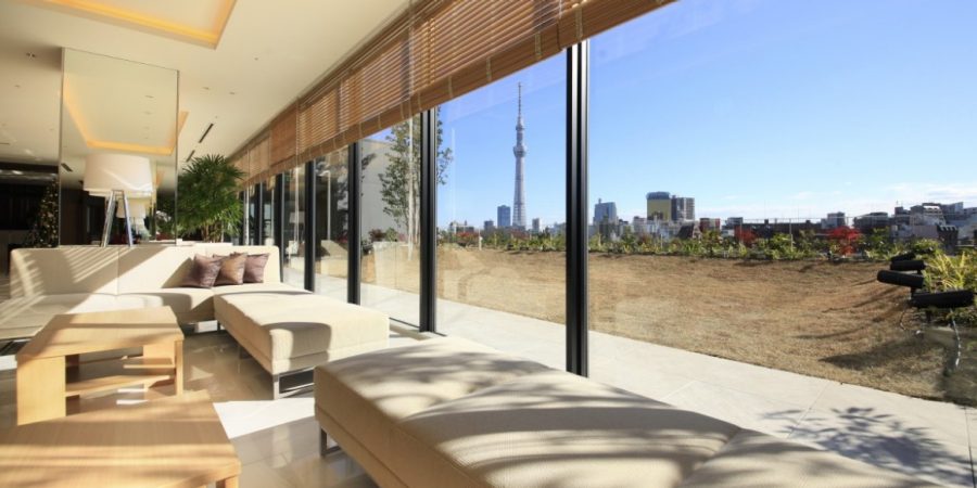 A bright living room with large windows showcasing a stunning view of the city skyline.