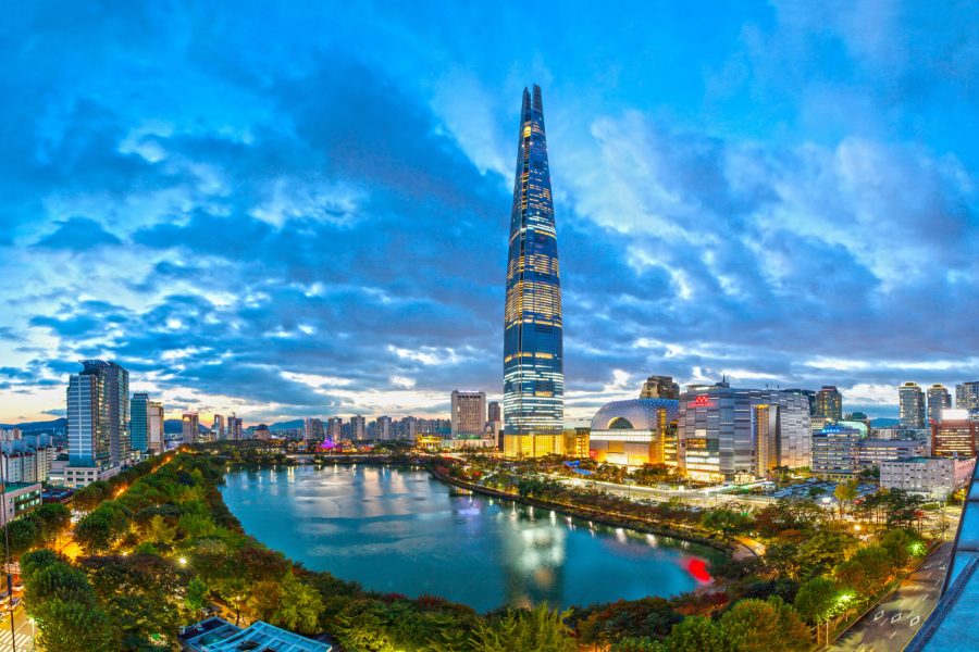 The image features Signiel Seoul, standing prominently in the cityscape against a clear sky.