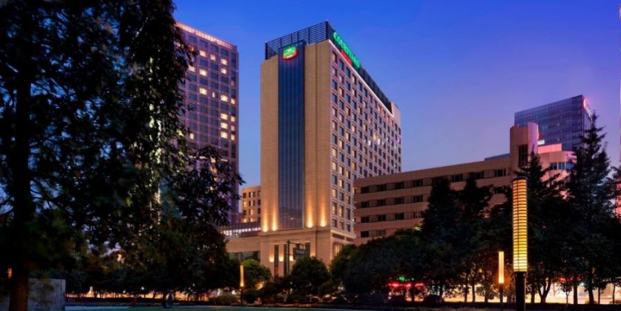 Night view of the hotel’s exterior, with warm lights highlighting its design and inviting atmosphere.