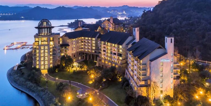 A dusk view of the resort, beautifully lit with glowing lights as night approaches.