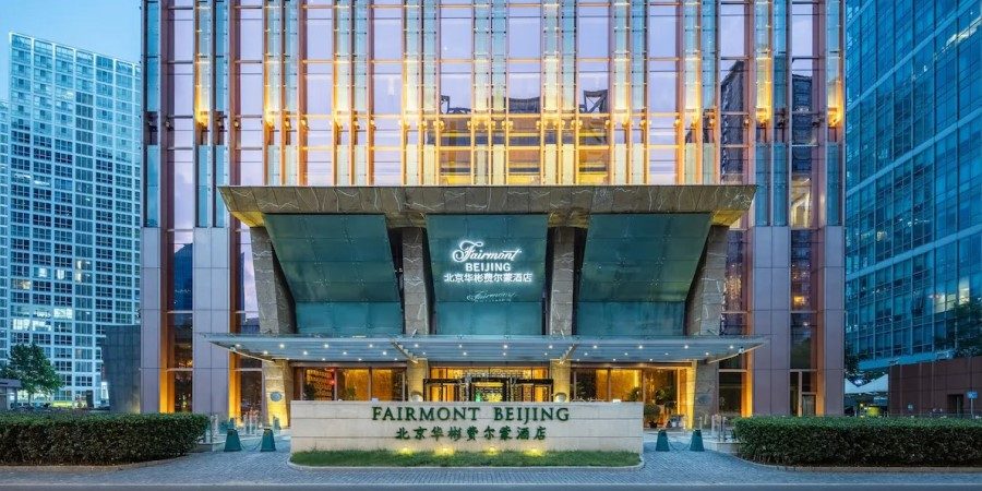 Exterior view of hotel, featuring sleek design and surrounding urban landscape.