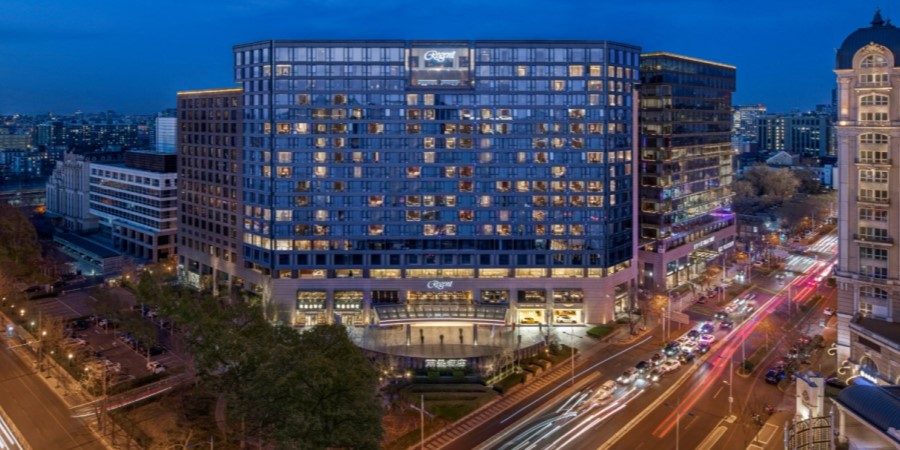 Exterior view of hotel, showcasing its contemporary design and landscaped surroundings.