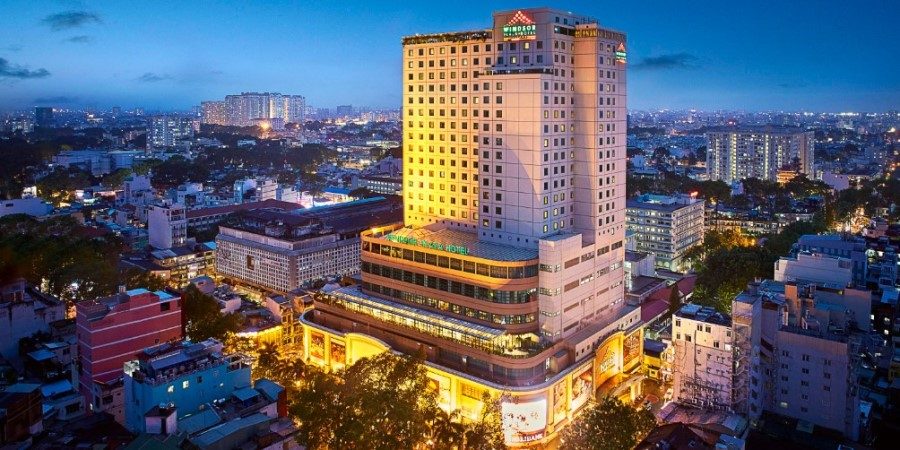 A towering hotel located in the heart of a city, showcasing modern architecture amidst the urban landscape.