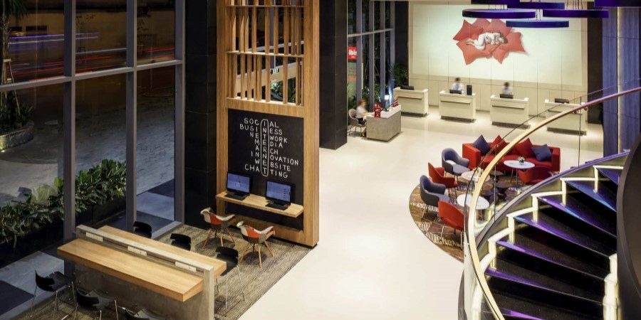 A stylish hotel lobby showcasing a spiral staircase and elegant decor.