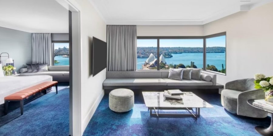 A luxurious suite overlooking Sydney Harbour, showcasing stunning views of the water and iconic landmarks.