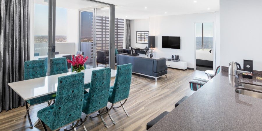  A modern apartment featuring a sleek kitchen, cozy dining area, and inviting living room with contemporary decor.