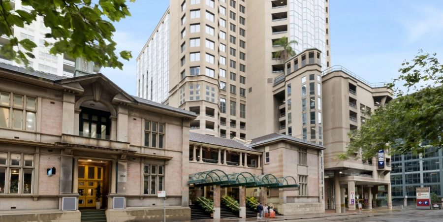 A hotel located at the corner of a street, showcasing its entrance and surrounding urban landscape.