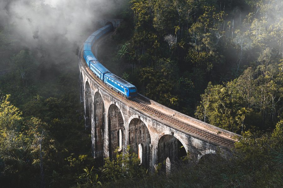 A train crosses a fog-covered bridge, creating a mysterious and atmospheric scene.