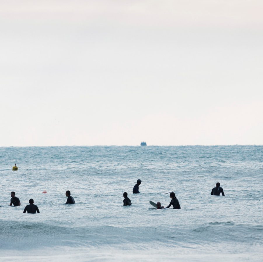 A few of sunrise thrillseekers at the Big Wave Bay, Hong Kong