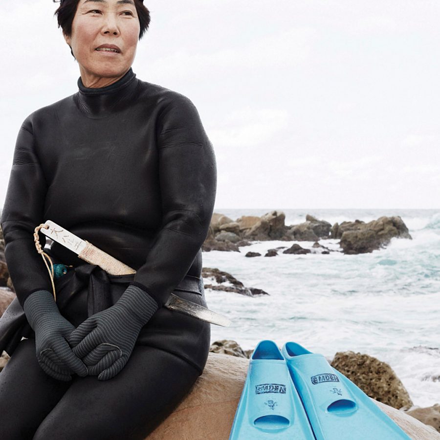 Diver sat by sea in diving geat