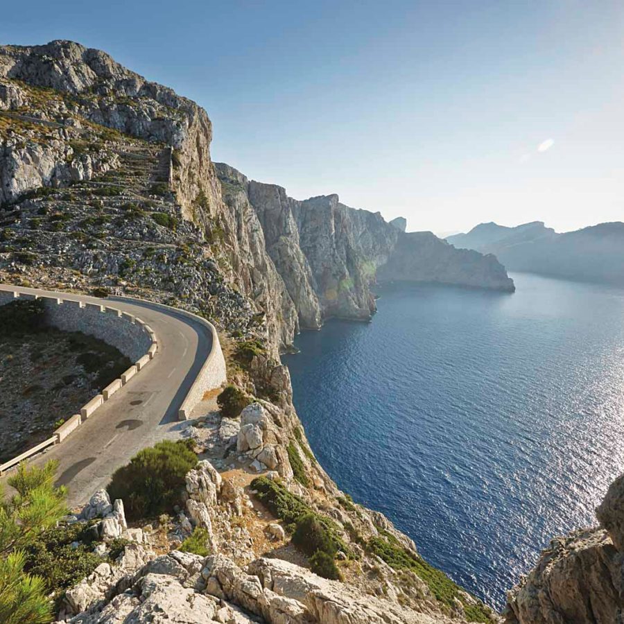 Beautiful cliffside highway over blue ocean in the sunlight