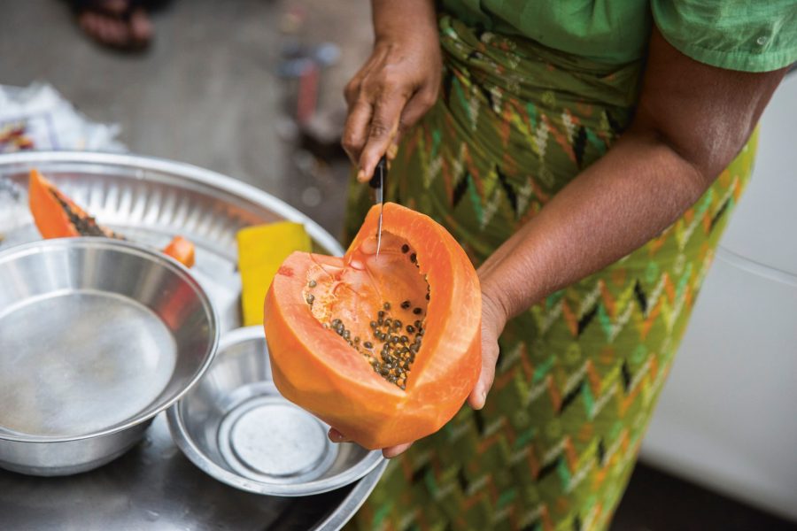 Woman cutting up papaya
