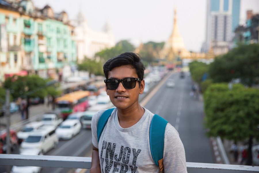 James, a food tour guide, is photographed in front of Sule Pagoda in Yangon, Myanmar 