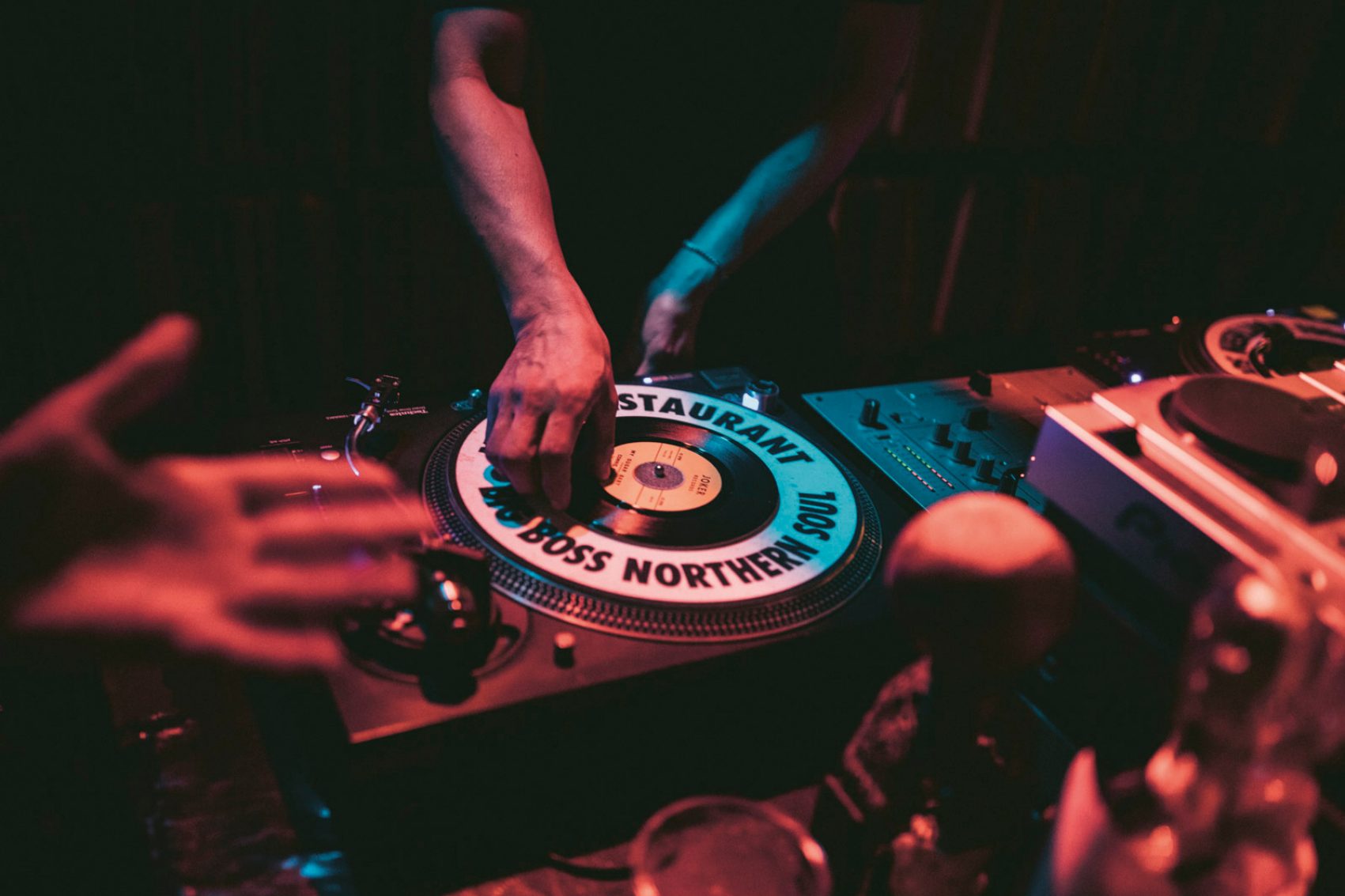 DJ spinning decks. Credit: Aaron Joel Santos