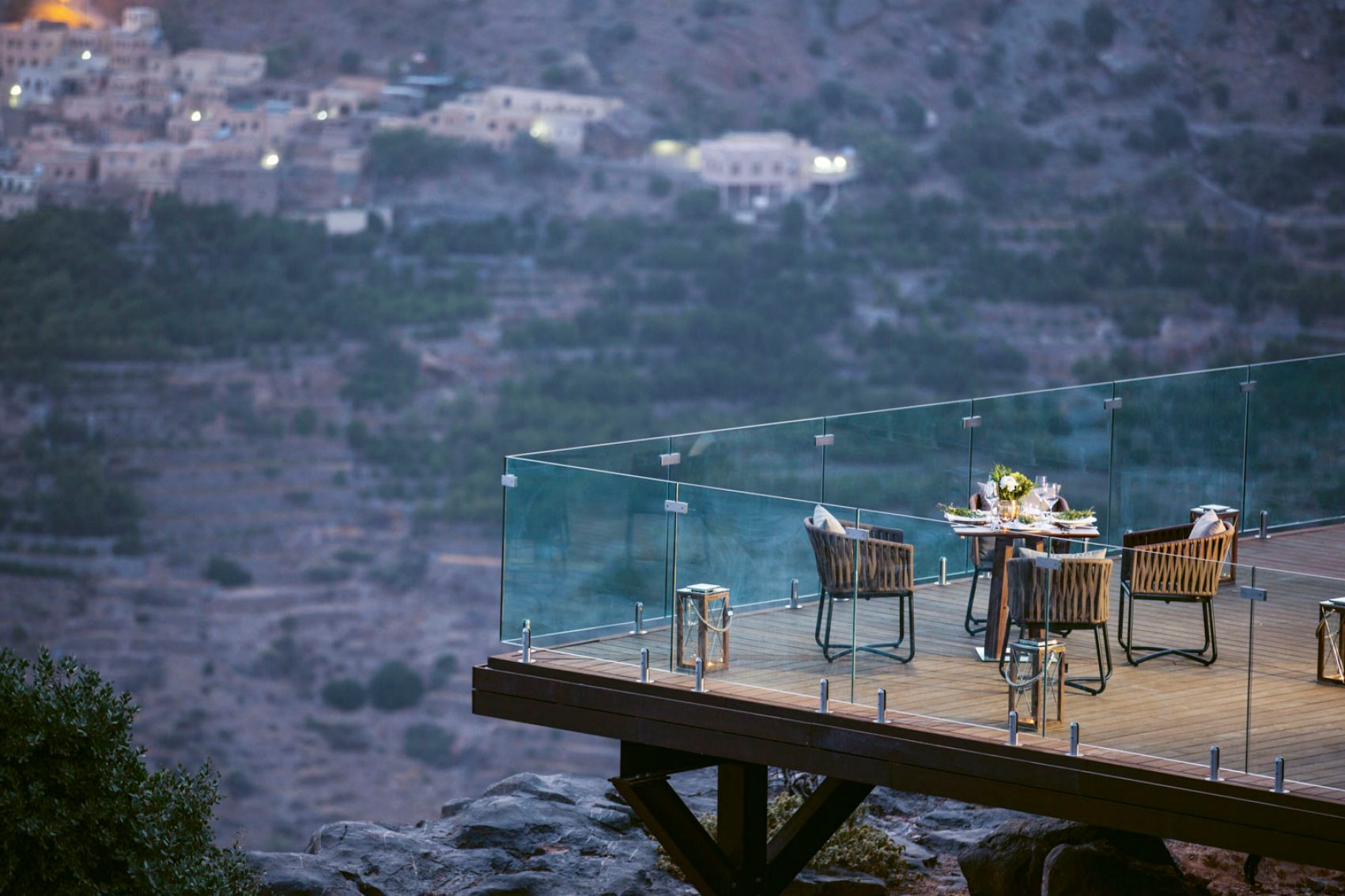 Balcony with tables and chairs overlooking Oman
