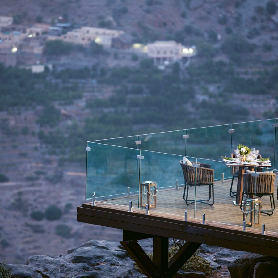 Balcony with tables and chairs overlooking Oman