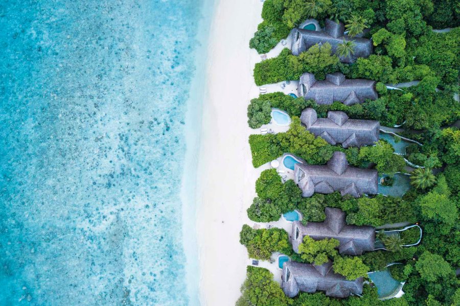 Aerial shot of villas in Maldives on a beach