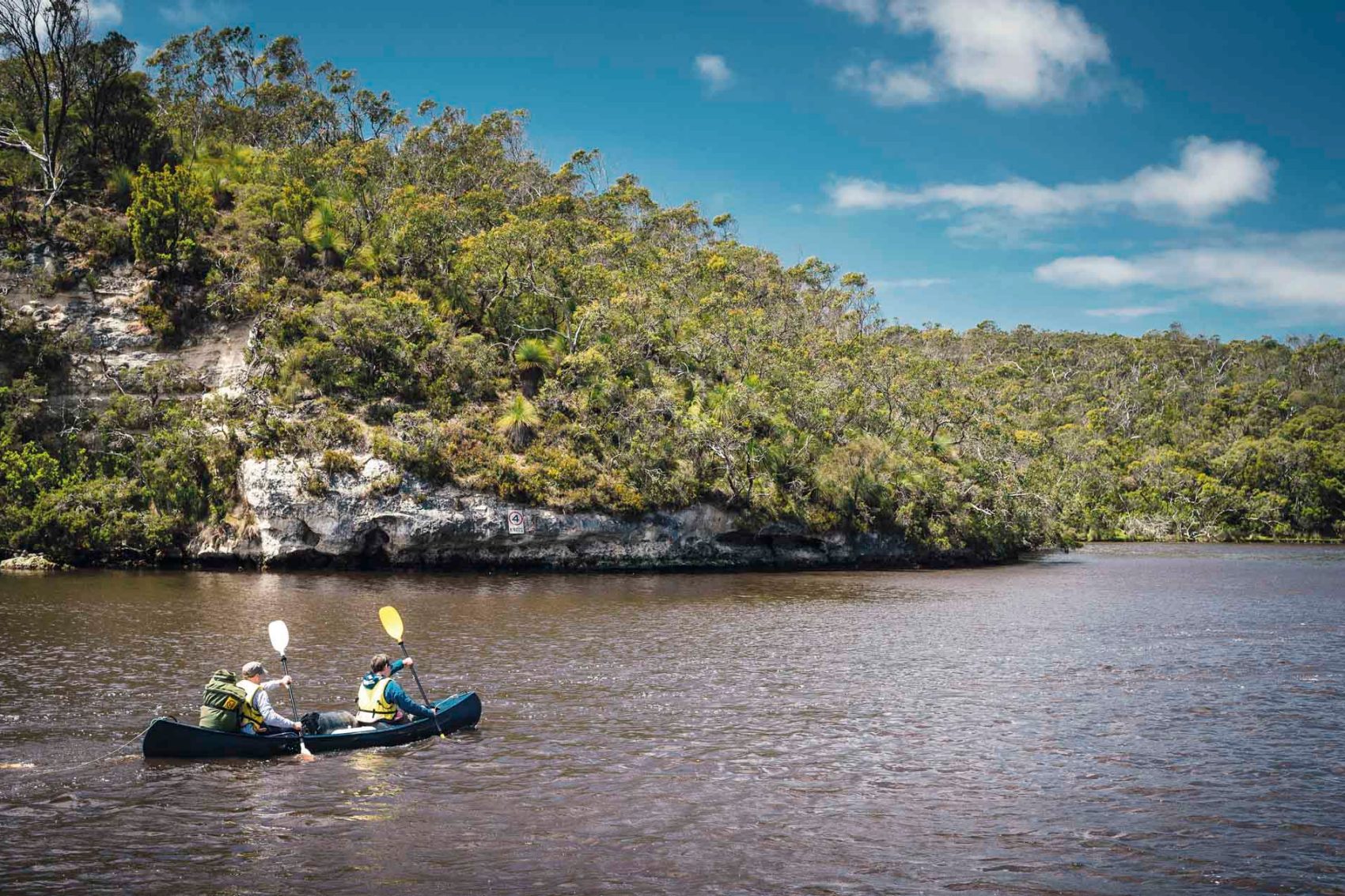 Two men in a kayak on a lake 
