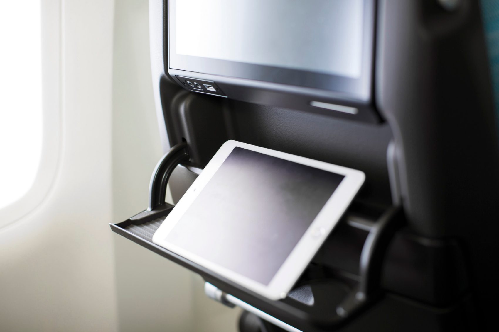 iPad standing upright in an aircraft seatback 