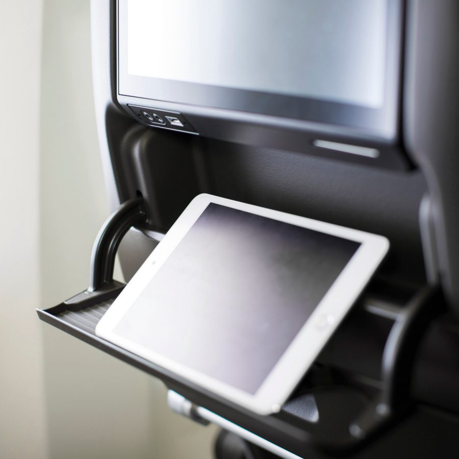 iPad standing upright in an aircraft seatback 