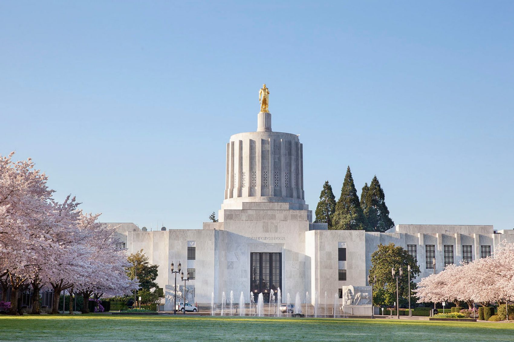 Salem Oregon State Capitol Building with Flowering Cherry Blossom Trees in Spring Season