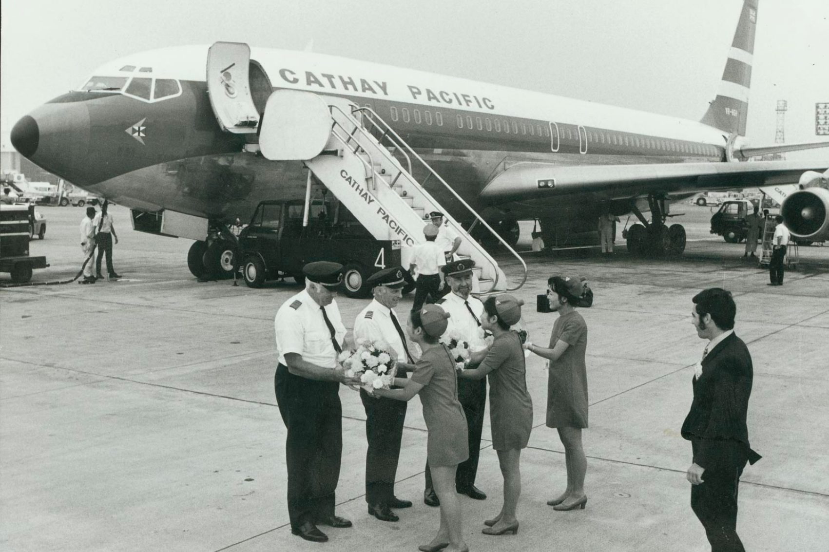 Cathay Pacific pilots being greeted after touching down in the new Boeing 707 aircraft