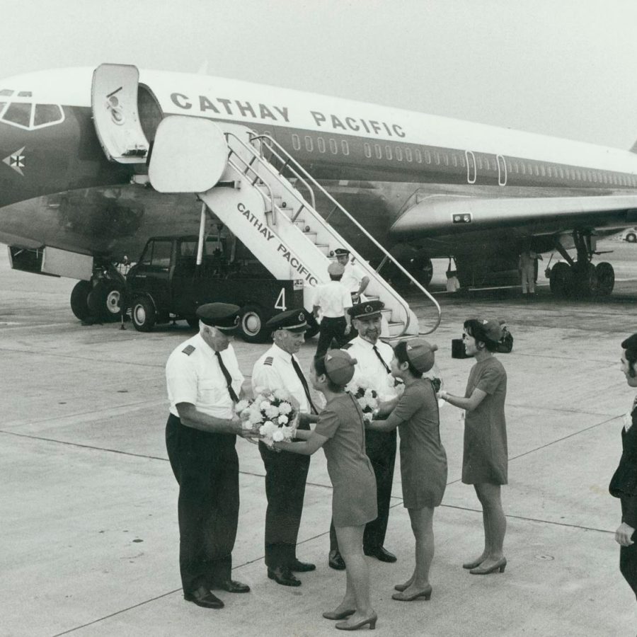 Cathay Pacific pilots being greeted after touching down in the new Boeing 707 aircraft