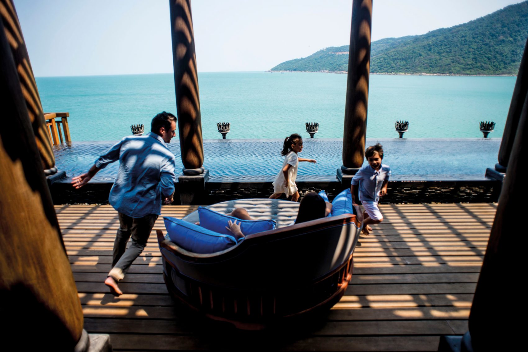Family playing together at a resort overlooking the water