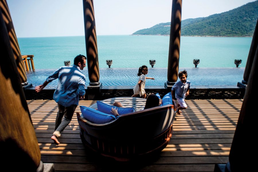 Family playing together at a resort overlooking the water