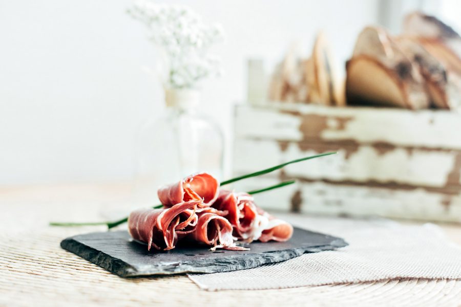 Pieces of ham on a charcoal slab.