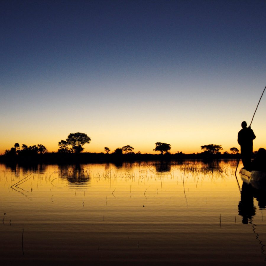 Men on a riverboat at sunset 