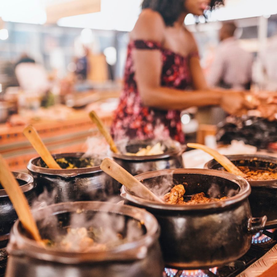 Woman cooking over a stove with multiple pots
