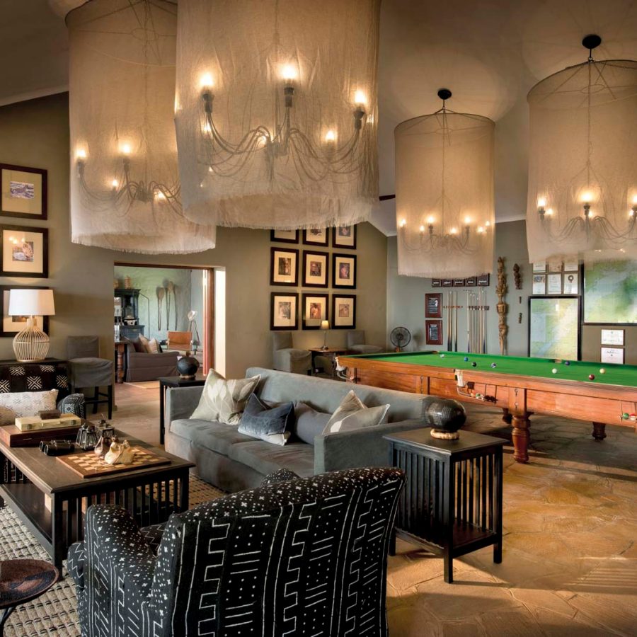 Warmly lit living area with a pool table