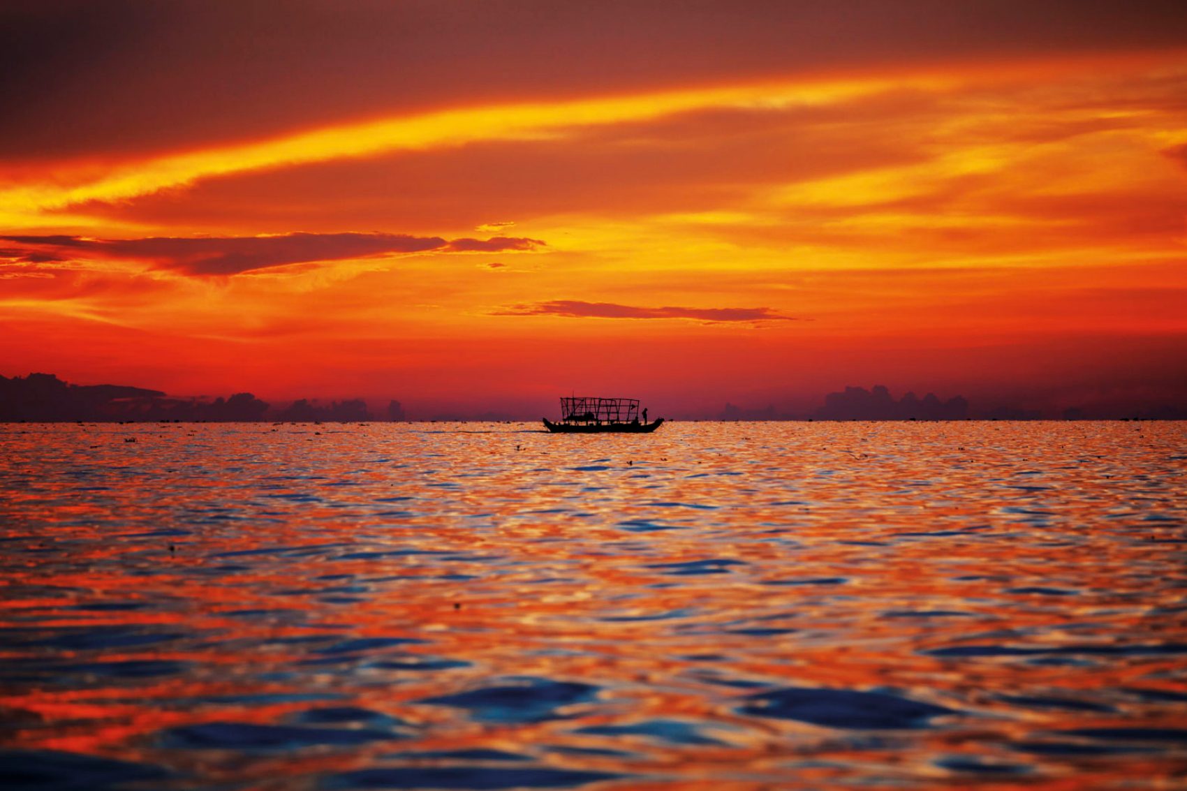 Boat on the ocean at sunset
