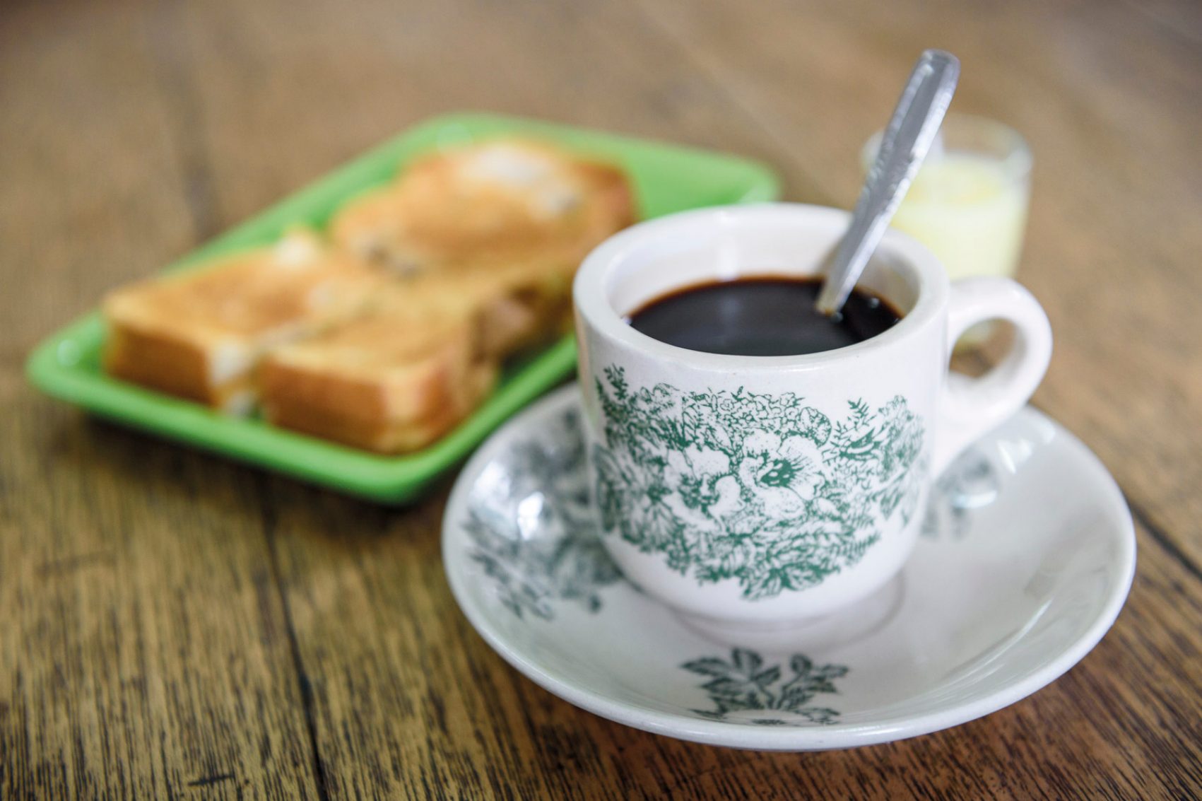 Cup of black coffee and a toasted sandwich