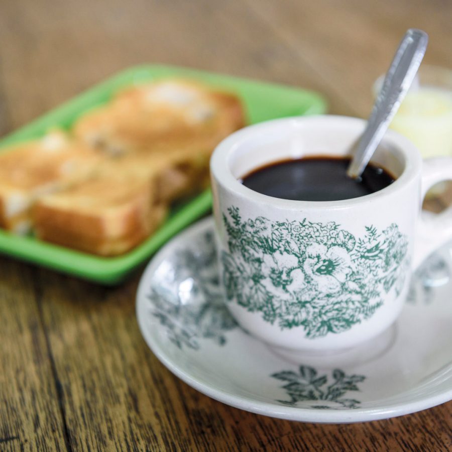 Cup of black coffee and a toasted sandwich