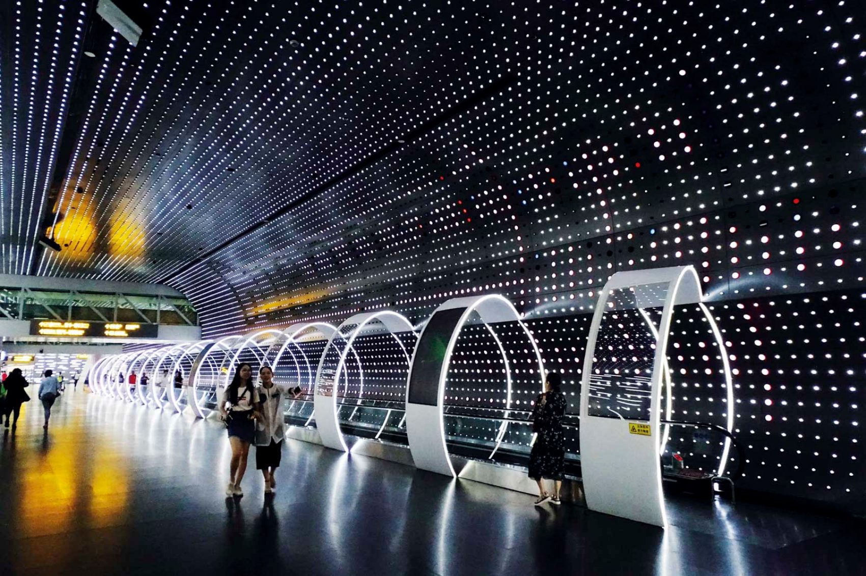 People along the time-space tunnel inside the Guangzhou Baiyun International Airport in Guangzhou (Greater Bay Area)