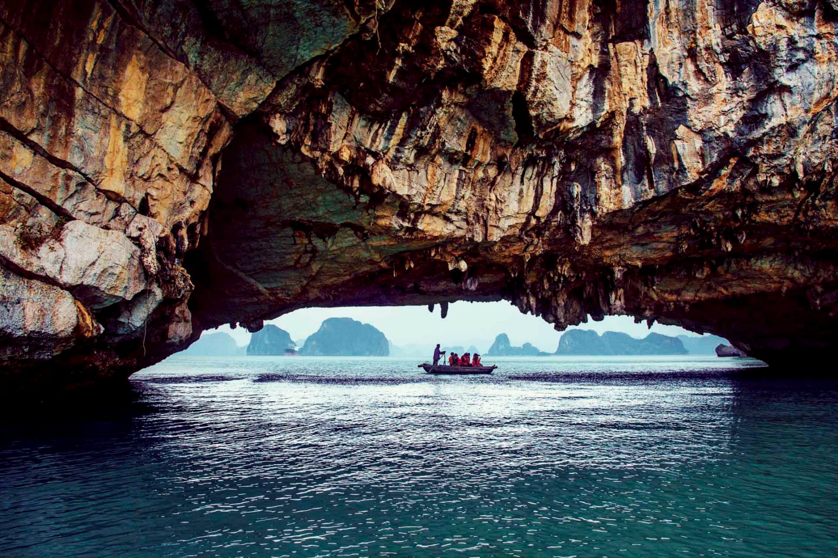 Vietnam, Rowing tourists through a cave at Halong Bay