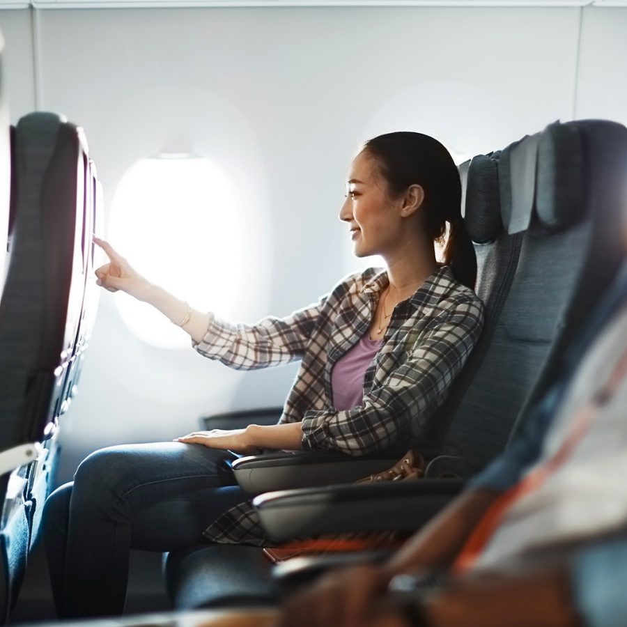 A passenger in the cabin touching the screen